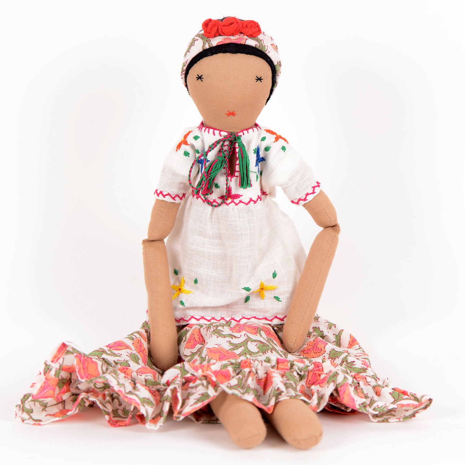 Frida, a handcrafted Afghan doll with vibrant floral patterns and intricate embroidery, symbolizing resilience and empowerment.